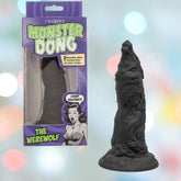 A black silicone adult toy, Monster Dong The Werewolf by CalExotics, stands upright beside its comic-style box featuring a surprised cartoon woman and vibrant retro design.